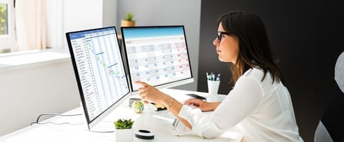 woman in front of computer trying to maximise print budget